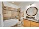 Bathroom featuring a tub, tile backsplash, and granite vanity top at 383 S Franklin St, Denver, CO 80209
