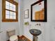 Chic bathroom with a glass vessel sink, decorative mirror, and a window for natural light at 383 S Franklin St, Denver, CO 80209