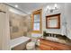 Neutral bathroom featuring tile, a window with wood trim, and modern fixtures at 383 S Franklin St, Denver, CO 80209
