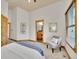 Spacious bedroom featuring a sitting area and view of en suite bathroom at 383 S Franklin St, Denver, CO 80209
