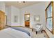 Spacious bedroom with a view of ensuite bathroom, featuring a walk-in closet and neutral color scheme at 383 S Franklin St, Denver, CO 80209