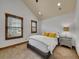 Comfortable bedroom with vaulted ceiling, carpet, and wooden window frames at 383 S Franklin St, Denver, CO 80209
