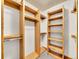 Walk-in closet featuring custom wooden shelving and neutral carpet at 383 S Franklin St, Denver, CO 80209