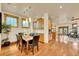 Bright dining room featuring hardwood floors, a modern light fixture, and built-in cabinetry for elegant dining at 383 S Franklin St, Denver, CO 80209