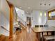 Spacious foyer features wood floors, an elegant staircase, and an adjacent dining area with pendant lighting at 383 S Franklin St, Denver, CO 80209