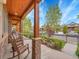 Front porch features rocking chairs, stone pillars, wood ceiling, and neighborhood views at 383 S Franklin St, Denver, CO 80209