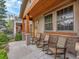 Inviting front porch with wood columns, stone accents, rocking chairs and stained wood ceiling at 383 S Franklin St, Denver, CO 80209