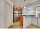 Well-appointed kitchenette with stainless steel refrigerator, wooden cabinets, bar top and tile floor at 383 S Franklin St, Denver, CO 80209