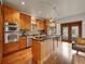 Gourmet kitchen with stainless steel appliances, granite countertops, a large island, and hardwood floors at 383 S Franklin St, Denver, CO 80209