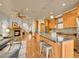 Open kitchen and living area with granite countertops, island seating, and a stone fireplace at 383 S Franklin St, Denver, CO 80209
