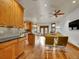 Open-concept kitchen with wooden cabinets, granite countertops, stainless steel appliances, and hardwood floors at 383 S Franklin St, Denver, CO 80209