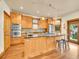 This kitchen features an island with stainless steel appliances, custom wood cabinets and hardwood floors at 383 S Franklin St, Denver, CO 80209