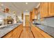 Gourmet kitchen with long island, gas cooktop, granite counters, wood cabinets, and stainless steel appliances at 383 S Franklin St, Denver, CO 80209