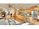 Open kitchen with stainless steel appliances, wood cabinets, granite countertops, and breakfast bar seating for casual dining at 383 S Franklin St, Denver, CO 80209