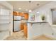 Basement kitchenette with stainless steel refrigerator and granite countertops at 383 S Franklin St, Denver, CO 80209