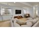 Bright living area features large windows, modern media center, and comfortable sectional sofa seating at 383 S Franklin St, Denver, CO 80209
