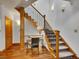 Detailed staircase featuring carpeted steps, wrought iron railings, and a small desk area at 383 S Franklin St, Denver, CO 80209