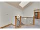 Well-lit staircase featuring carpeted steps, wood railings, and a skylight at 383 S Franklin St, Denver, CO 80209