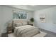 Bright bedroom featuring a cozy bed, soft lighting, and ample natural light through a window at 2565 S Sheridan Blvd # 14, Lakewood, CO 80227