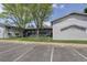 Apartment complex with stairs and ample parking; view of the building and surrounding greenery at 2565 S Sheridan Blvd # 14, Lakewood, CO 80227