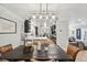 Bright dining room with a dark wood table and leather chairs, open to kitchen at 4360 S Alton Ct, Greenwood Village, CO 80111