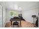 Bright home office featuring hardwood floors and a grand piano at 4360 S Alton Ct, Greenwood Village, CO 80111