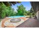 Relaxing pool area, brick patio, and surrounding landscaping at 4360 S Alton Ct, Greenwood Village, CO 80111