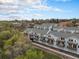 Aerial view of the property complex with tree-lined landscaping and private garages at 6240 Everett Ct # D, Arvada, CO 80004