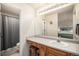 Well-lit bathroom with an expansive vanity, a separate shower, and an adjacent toilet at 6240 Everett Ct # D, Arvada, CO 80004