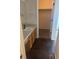 Bathroom vanity with light wood cabinets, matte black hardware, and laminate counters at 6240 Everett Ct # D, Arvada, CO 80004
