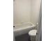 Bathroom with white tile shower-tub combination and modern toilet at 6240 Everett Ct # D, Arvada, CO 80004