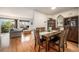 Dining room flowing into the living area features hardwood floors and abundant natural light at 6240 Everett Ct # D, Arvada, CO 80004