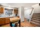 Bright entryway showcases stairs leading to the upper level, hardwood flooring, and kitchen views at 6240 Everett Ct # D, Arvada, CO 80004