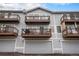Exterior showcasing balconies and garages for each townhome unit at 6240 Everett Ct # D, Arvada, CO 80004