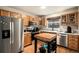 Well-lit kitchen featuring stainless steel appliances, wood cabinets, and a butcher block island on hardwood flooring at 6240 Everett Ct # D, Arvada, CO 80004