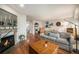 Open-concept living room with hardwood floors, fireplace, and comfortable seating at 6240 Everett Ct # D, Arvada, CO 80004