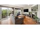 Bright living room featuring hardwood floors, fireplace, and balcony access at 6240 Everett Ct # D, Arvada, CO 80004