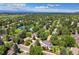 Aerial view of a community with a pool, tennis court, and tree-lined streets at 7193 S Newport Way, Centennial, CO 80112
