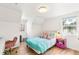 Bright bedroom featuring wood floors and a bed with colorful bedding at 7193 S Newport Way, Centennial, CO 80112