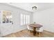 Dining room features a modern wood table with seating for four, clean white walls, and wood flooring at 7193 S Newport Way, Centennial, CO 80112