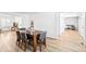 Inviting dining room features a wooden table with seating for six, light hardwood floors and ample natural light at 7193 S Newport Way, Centennial, CO 80112