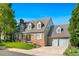 A brick two-story home with dormer windows, steps to the front door, and attached two-car garage at 7193 S Newport Way, Centennial, CO 80112