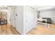 Bright hallway featuring hardwood floors, neutral walls, closet space, and access to multiple rooms at 7193 S Newport Way, Centennial, CO 80112