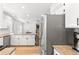 A spacious kitchen featuring granite countertops, stainless steel appliances, and white cabinetry at 7193 S Newport Way, Centennial, CO 80112