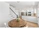 Bright kitchen view showcasing a round wooden table, white cabinets, granite countertops and stainless steel appliances at 7193 S Newport Way, Centennial, CO 80112
