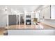 Kitchen featuring granite countertops, stainless steel appliances, white cabinets, and modern lighting at 7193 S Newport Way, Centennial, CO 80112