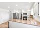 An open-concept kitchen with granite countertops, stainless steel appliances, and wood flooring at 7193 S Newport Way, Centennial, CO 80112