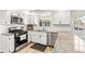 Kitchen featuring granite countertops, stainless steel appliances, white cabinets, and natural wood flooring at 7193 S Newport Way, Centennial, CO 80112