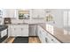 Bright kitchen featuring granite countertops, stainless steel appliances, and white cabinets at 7193 S Newport Way, Centennial, CO 80112
