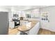 Kitchen featuring granite countertops, stainless steel appliances, white cabinets, and wood floors at 7193 S Newport Way, Centennial, CO 80112